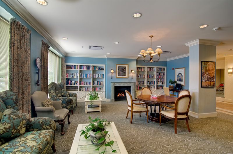 Interior view of Senior Suites Wright Campus featuring elegant decor, furniture, and residents.