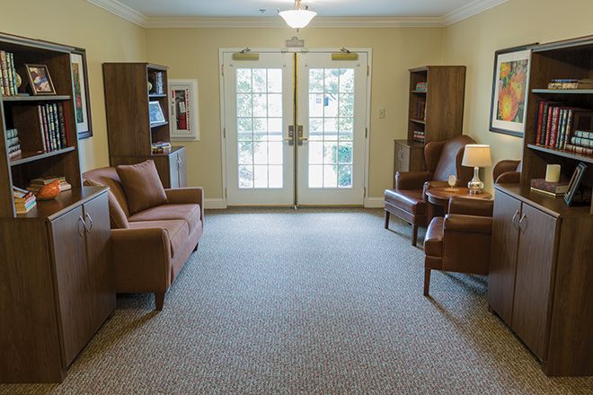 Interior view of Brookdale Johnson City senior living community featuring cozy furniture and library.