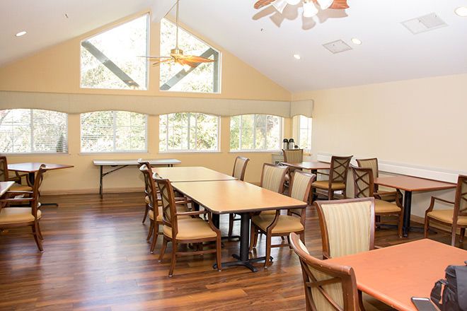 Interior view of Brookdale Roseville senior living community's dining area with wooden furniture.