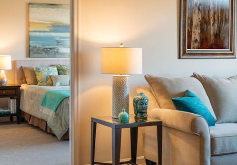 Senior living room interior at Lantern Hill with cozy furniture, table lamp, and home decor.