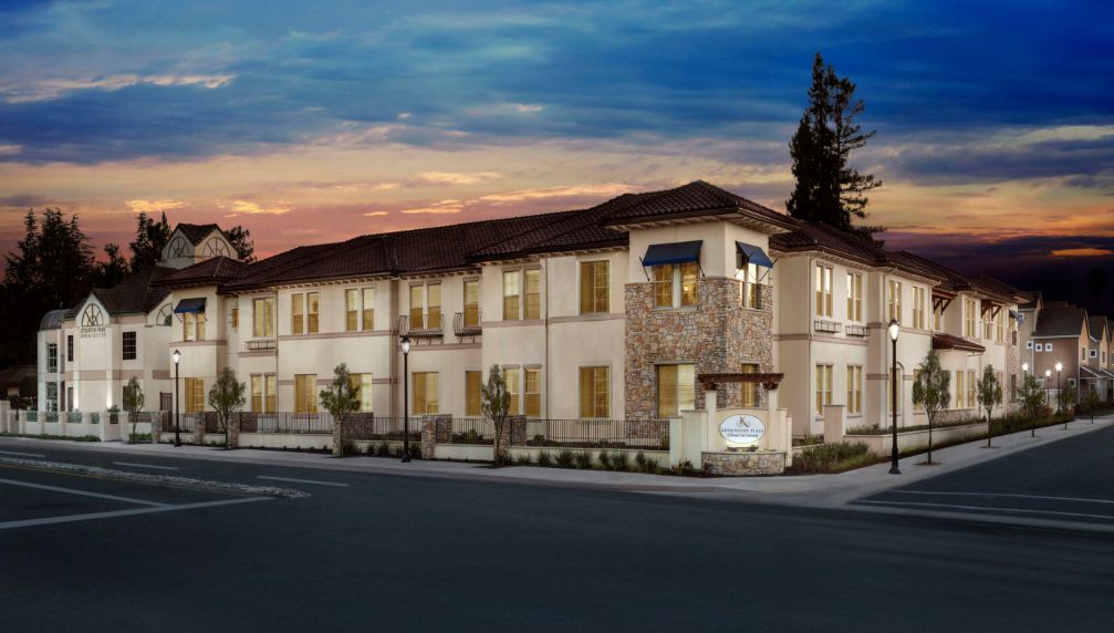 Kensington Place senior living community in Redwood City with modern architecture and lush trees.