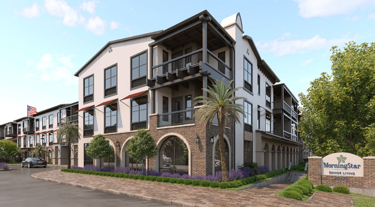 High-rise apartment building in urban neighborhood, Morningstar of Mission Viejo, with cars on street.