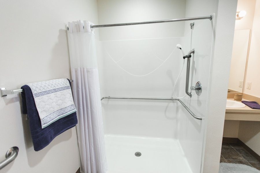Senior resident in a well-decorated bathroom with bathtub at Angels Senior Living in New Tampa.