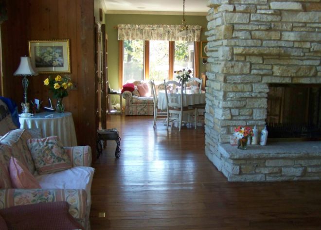 Interior view of Theresa's Assisted Living community featuring hardwood floors, cozy fireplace, and tasteful decor.