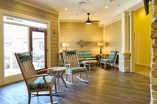 Interior view of Memory Care of Little Rock at Good Shepherd featuring hardwood floors and furniture.