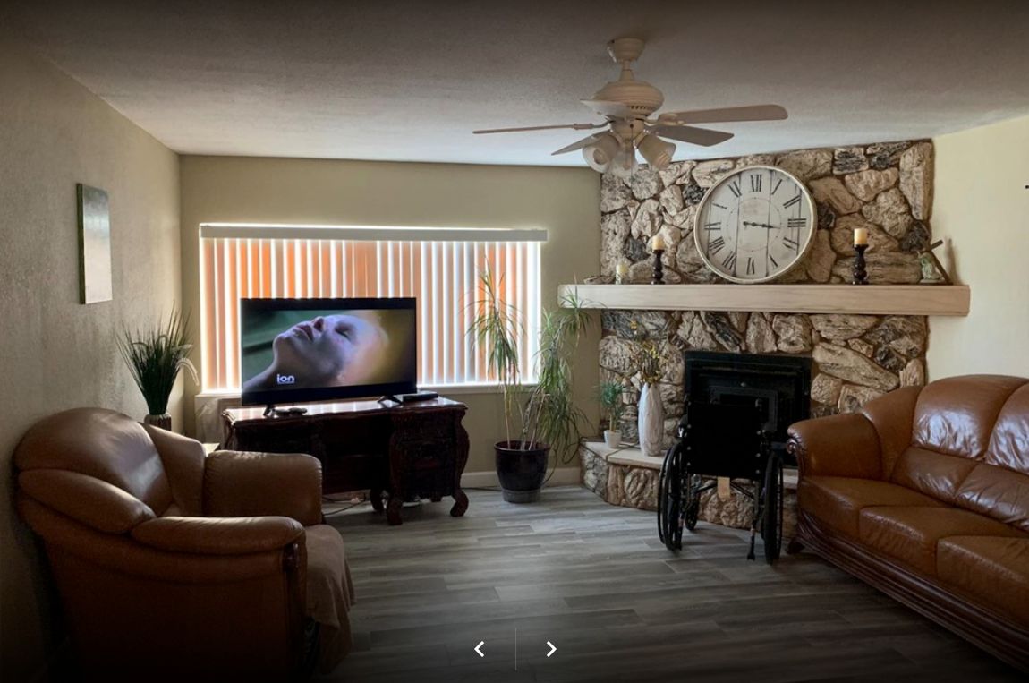 Senior man in a well-furnished living room at Amazing Grace Elder Care with modern amenities.