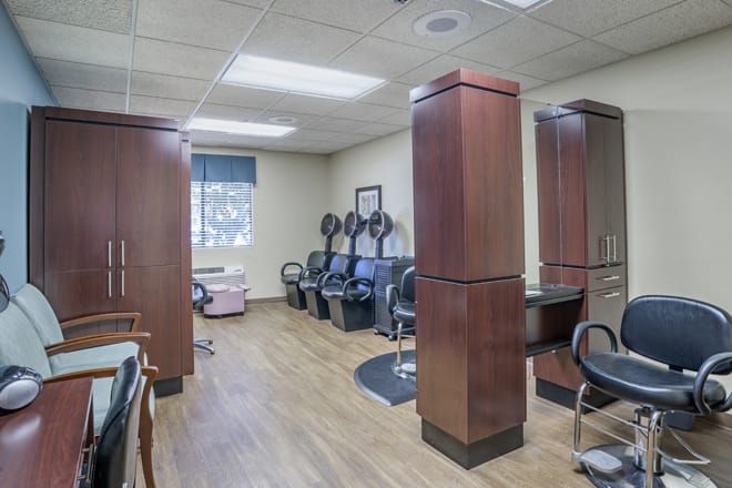 Interior view of Brookdale Irvine senior living community featuring a salon, barbershop, and computer area.