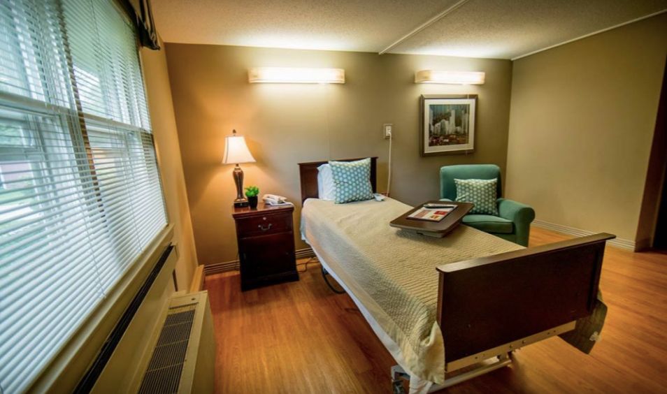 Home Decor and furniture in a cozy bedroom at Symphony of Morgan Park senior living community.