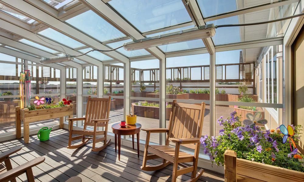 Interior and terrace design of Grayslake senior living community with garden view.
