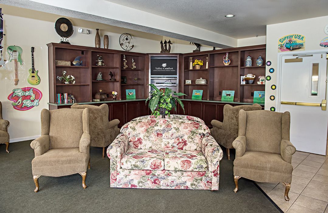 Senior living community interior with modern furniture, home decor, guitar, and car in view.