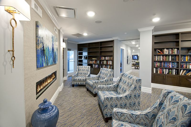 Interior view of Allegro Parkland senior living community featuring modern decor, library, and electronics.
