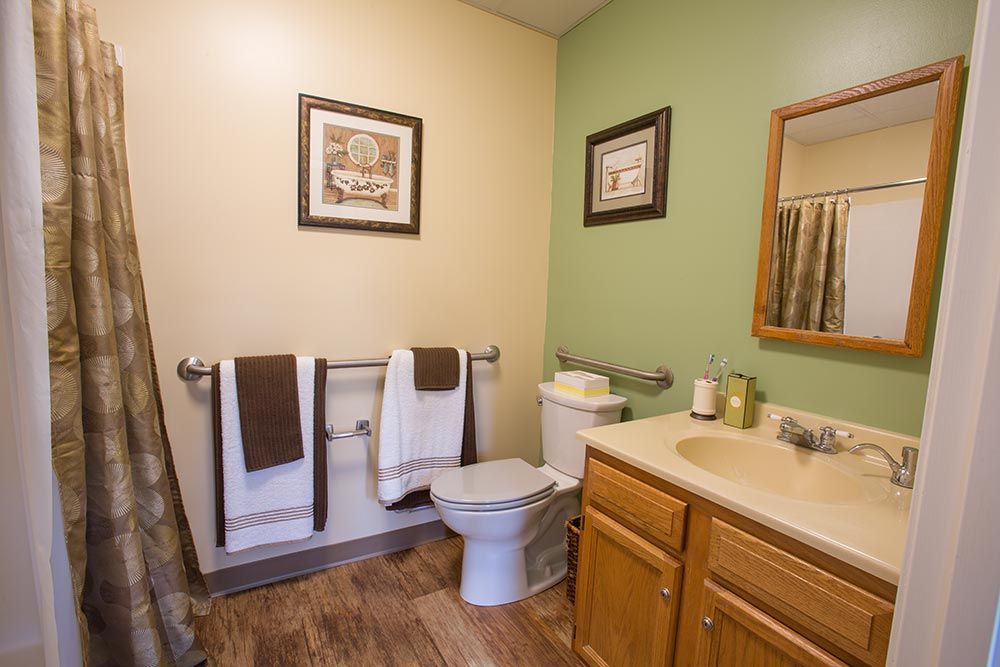 Interior view of Corner senior living community featuring art-filled bathroom with modern amenities.