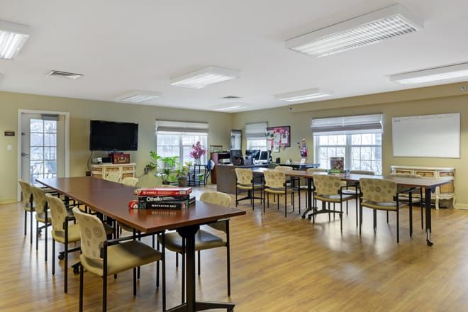 Senior living community Brookdale Cushing Park featuring dining area, computer room, and cozy decor.