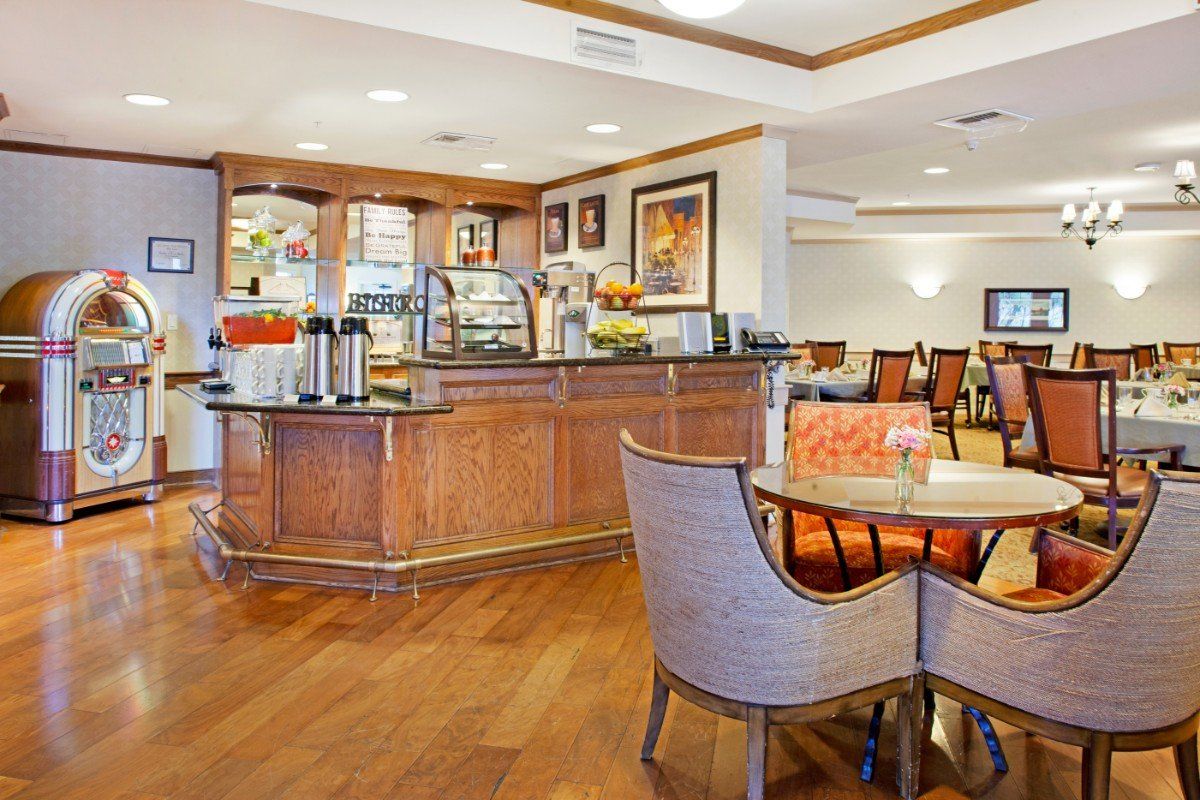 Interior view of Ivy Park at Wood Ranch senior living community featuring dining room and kitchen.