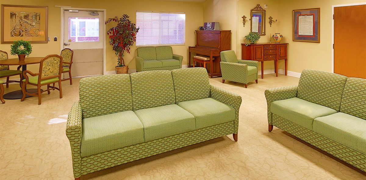 Senior living community Hickory Village featuring a well-furnished reception room with modern decor.