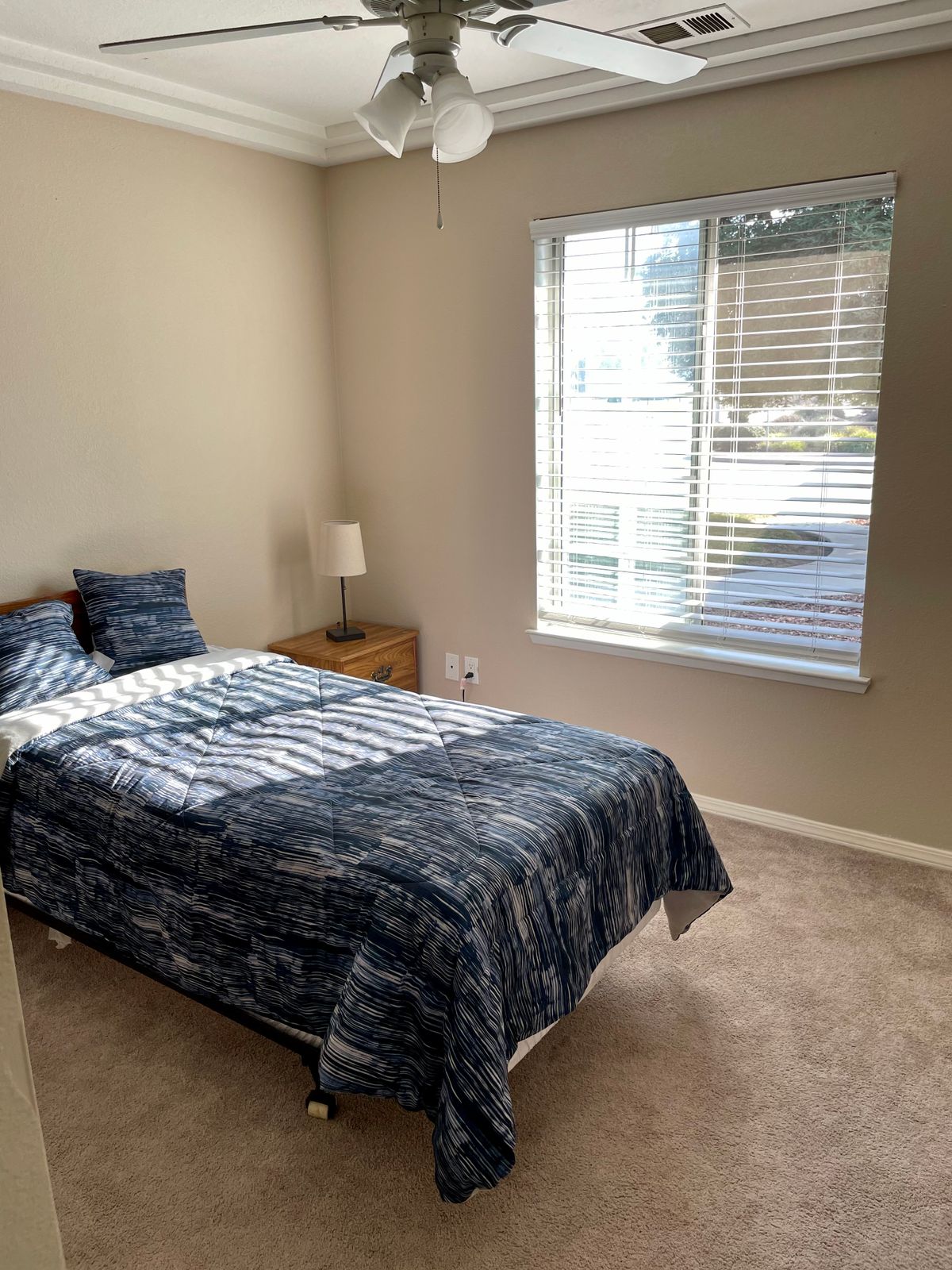 Interior view of a well-furnished bedroom at Rosewood Assisted Living with modern appliances.