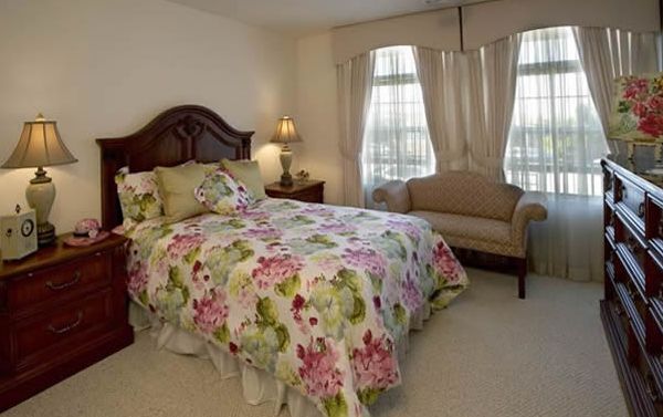 Bedroom interior at Magnolia of Millbrae senior living community featuring home decor and furniture.