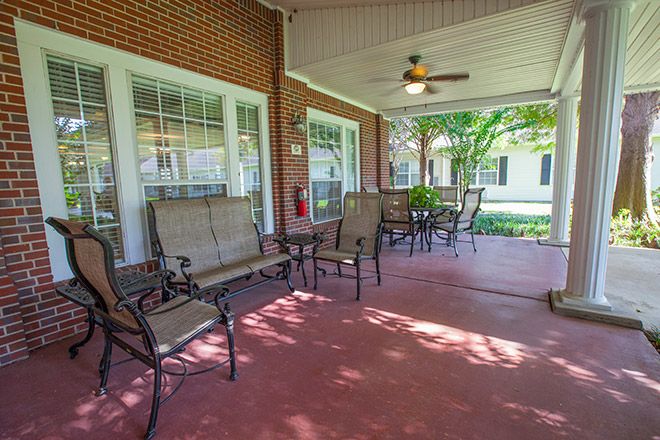 Senior living community Brookdale Sugar Land featuring porch with furniture, dining area, and appliances.