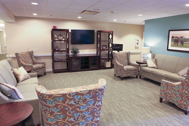 Interior view of Charter Senior Living of Edgewood featuring modern decor, furniture, and electronics.