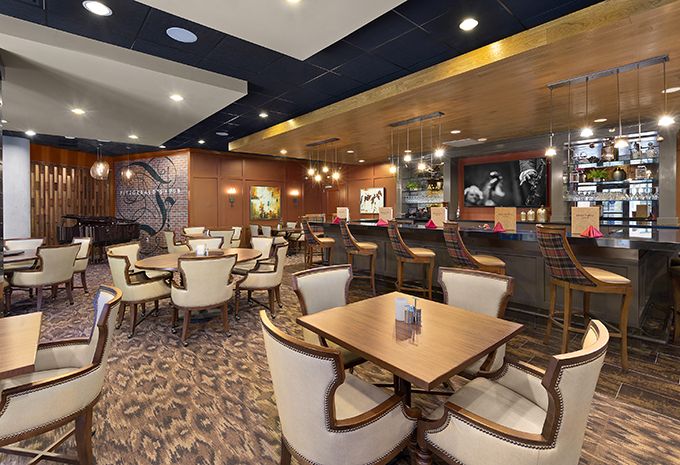 Interior view of Brightview West End senior living community featuring dining area and lounge.