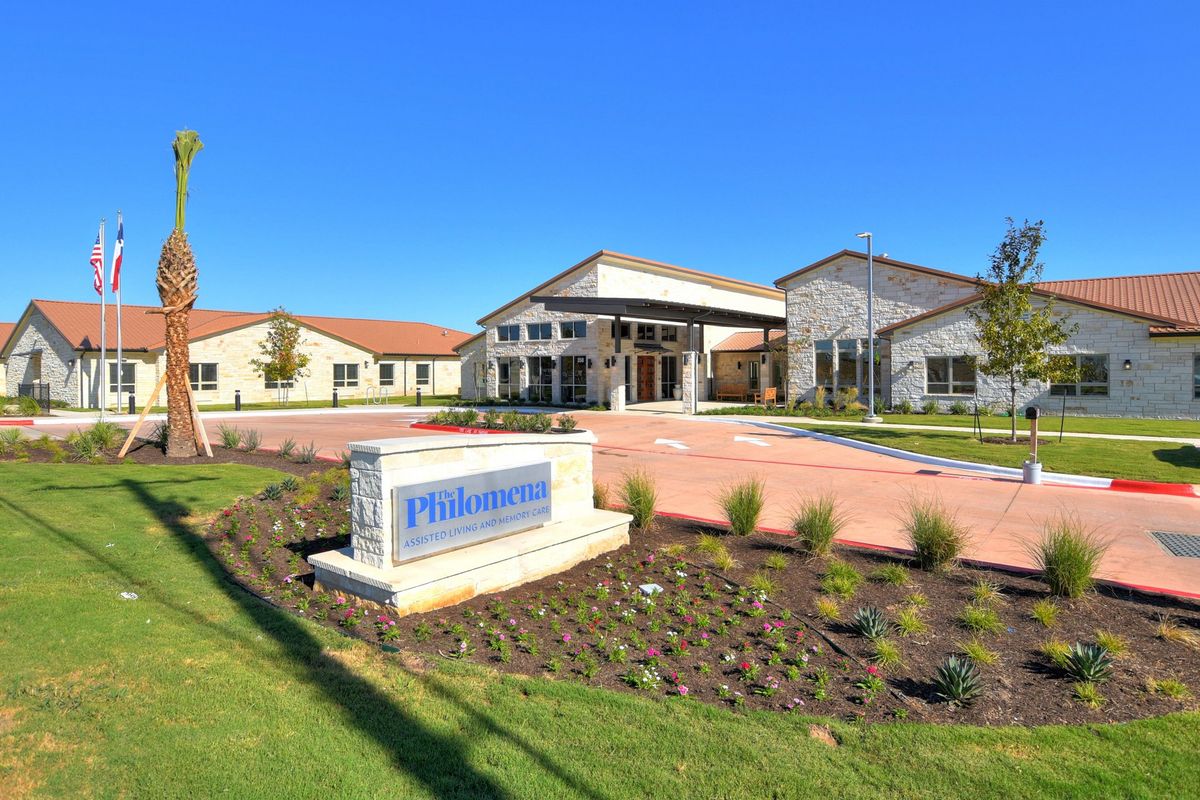 Grass-covered lawns and plant-filled neighborhood of the Grass Villa senior living community.