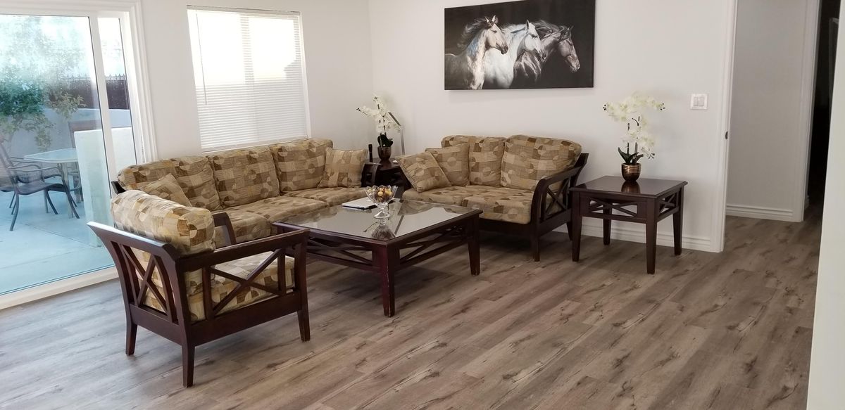 Interior view of Alalik Care Home featuring hardwood flooring, furniture, and horse decor.