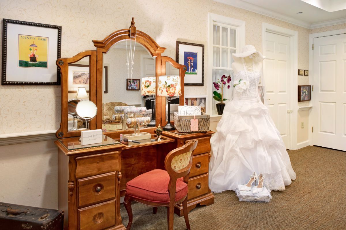 Bride in wedding gown in dressing room at Sunrise of Madison senior living community.