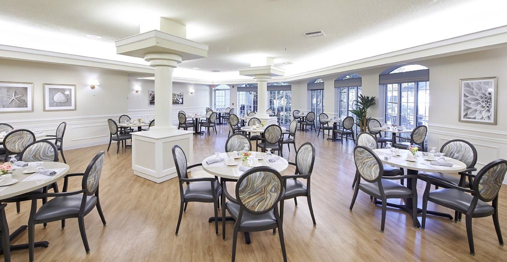 Senior living community Aldea Green's architectural building with dining room, reception, and art.