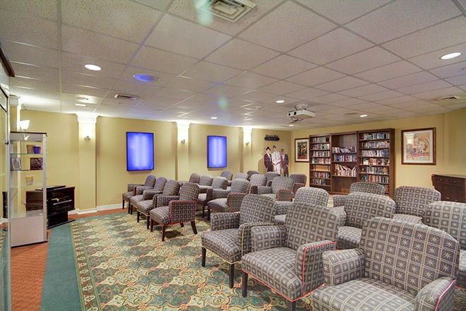 Senior living community lounge at Smithfield Woods featuring art, furniture, and modern amenities.