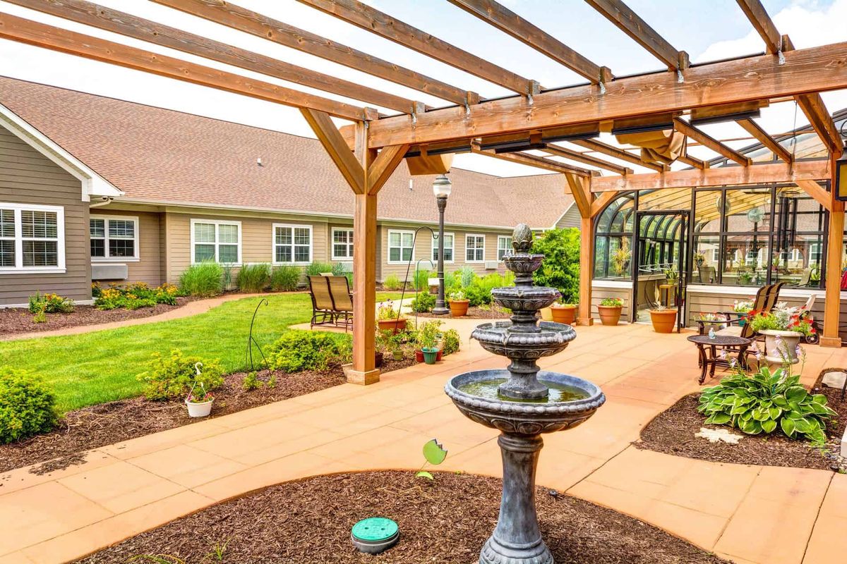 Senior living community, The Auberge At Naperville, featuring elegant architecture and lush gardens.