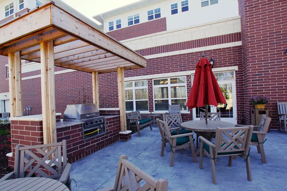 Interior and patio view of Oak Hill Supportive Living Community with modern furniture and architecture.