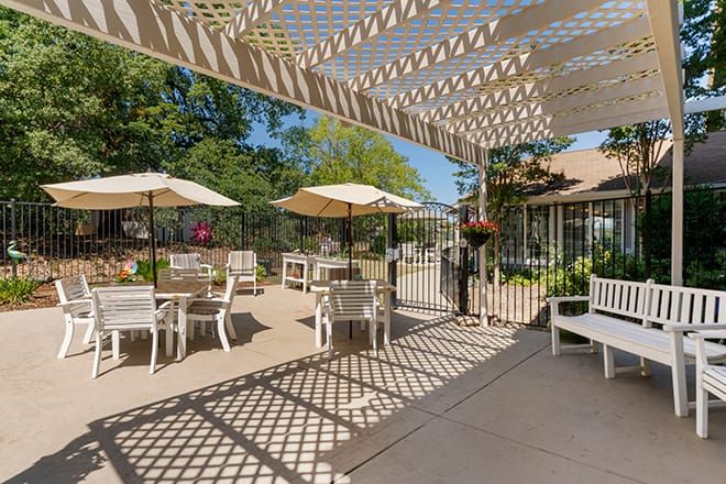Brookdale Auburn senior living community featuring patio dining, lush gardens, and modern interior design.