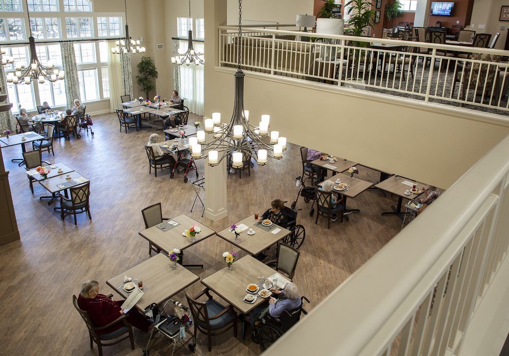 Senior residents enjoying mealtime in the spacious dining room of The Landing of Washington Square.
