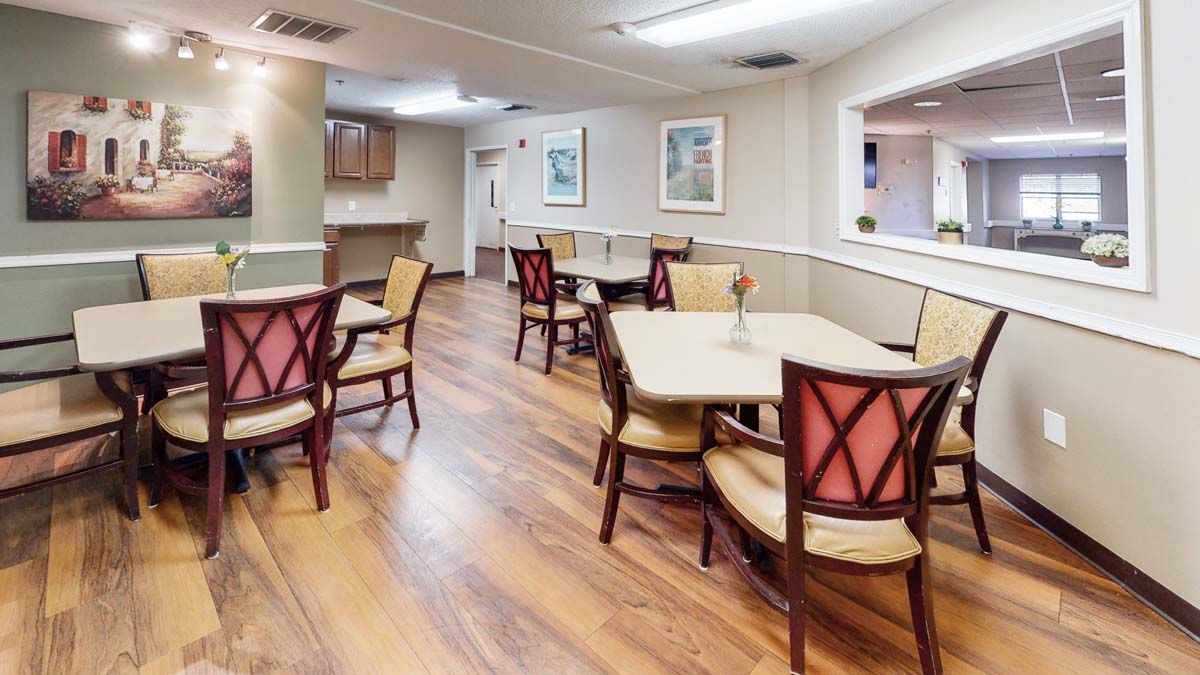 Interior view of Madison At Clermont senior living community featuring a wooden dining area.