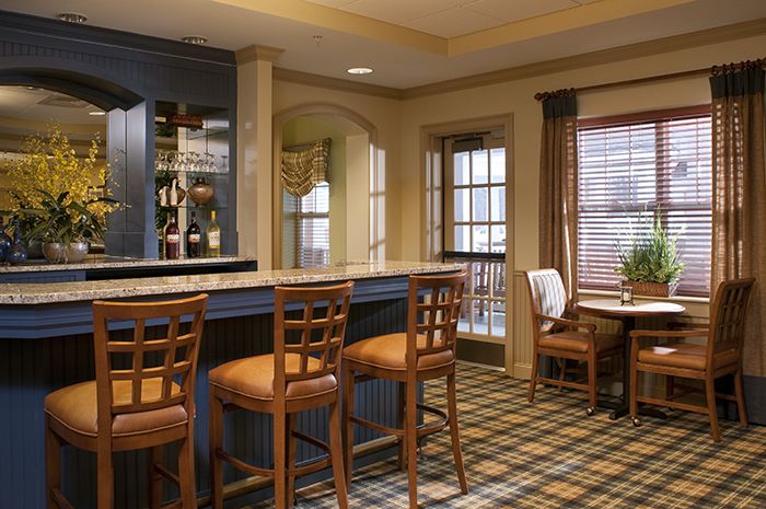 Dining room with elegant furniture and home decor in Brightview Concord River senior living community.