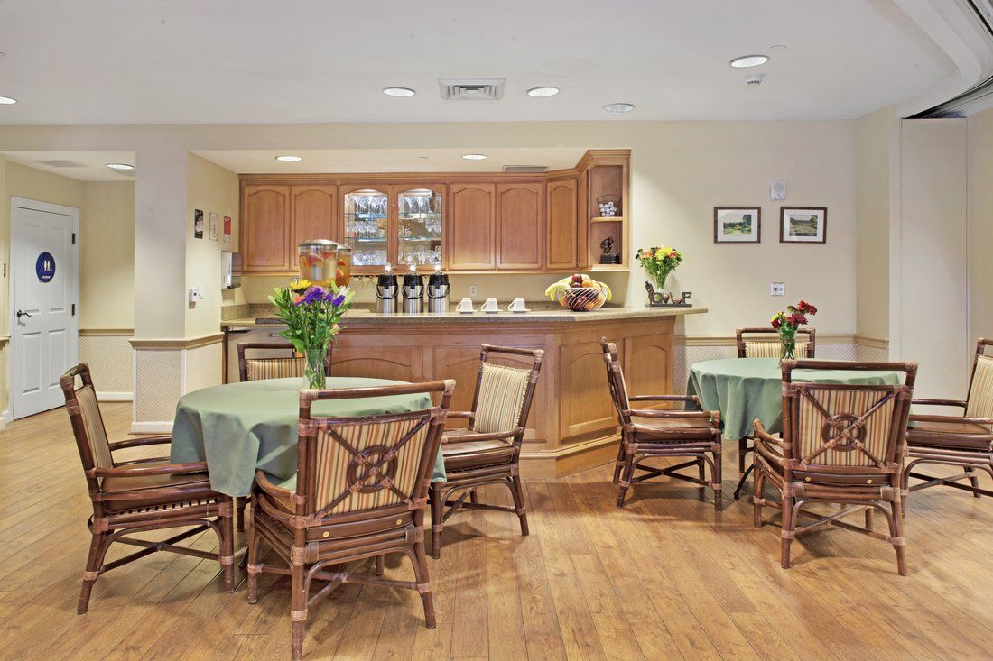 Interior view of Sunrise of Mission Viejo senior living community featuring dining room and kitchen.