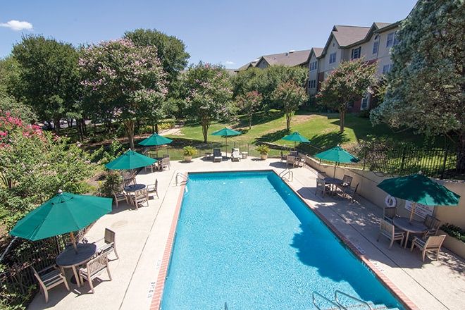Aerial view of Brookdale Westlake Hills senior living community with outdoor pool and lush yard.