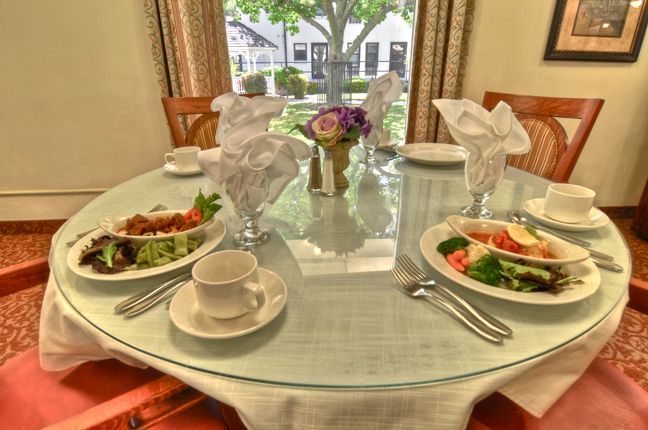Elegant dining room setup at California Mission Inn - Rose Manor senior living community.