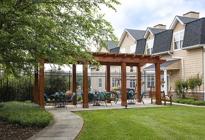 Brightview Baldwin Park senior living community featuring a porch, patio, pergola, and garden.