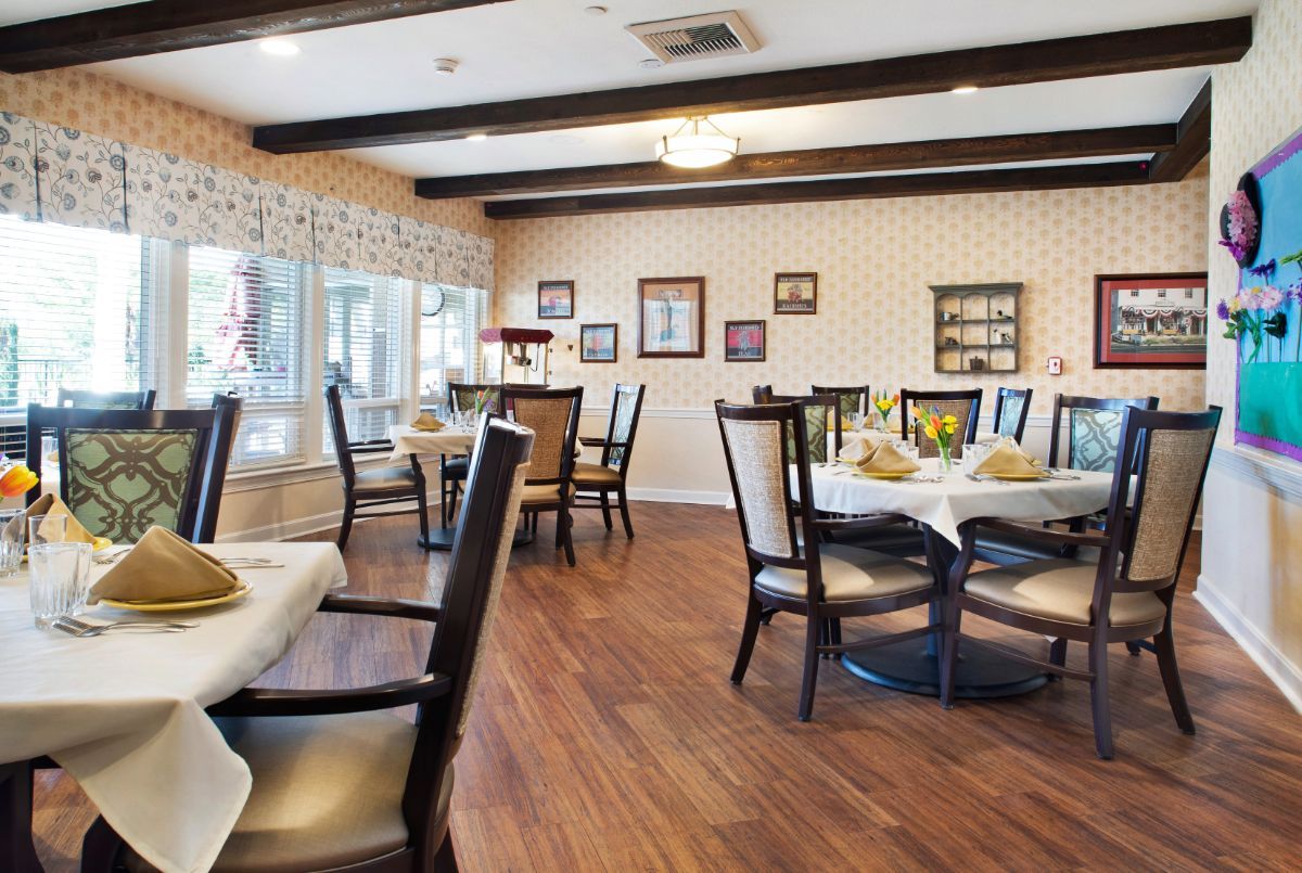 Interior view of Canyon Crest senior living community featuring a wooden dining room and furniture.
