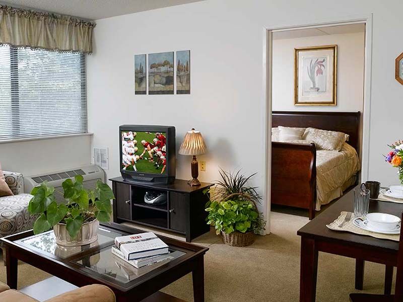 Senior living room at Celebration Villa of Highland Crossing with modern decor and amenities.
