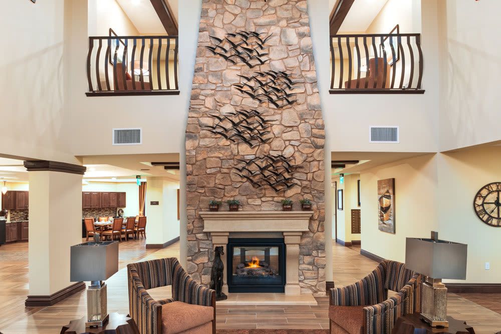 Interior view of Mariposa at Ellwood Shores senior living community featuring a cozy fireplace.