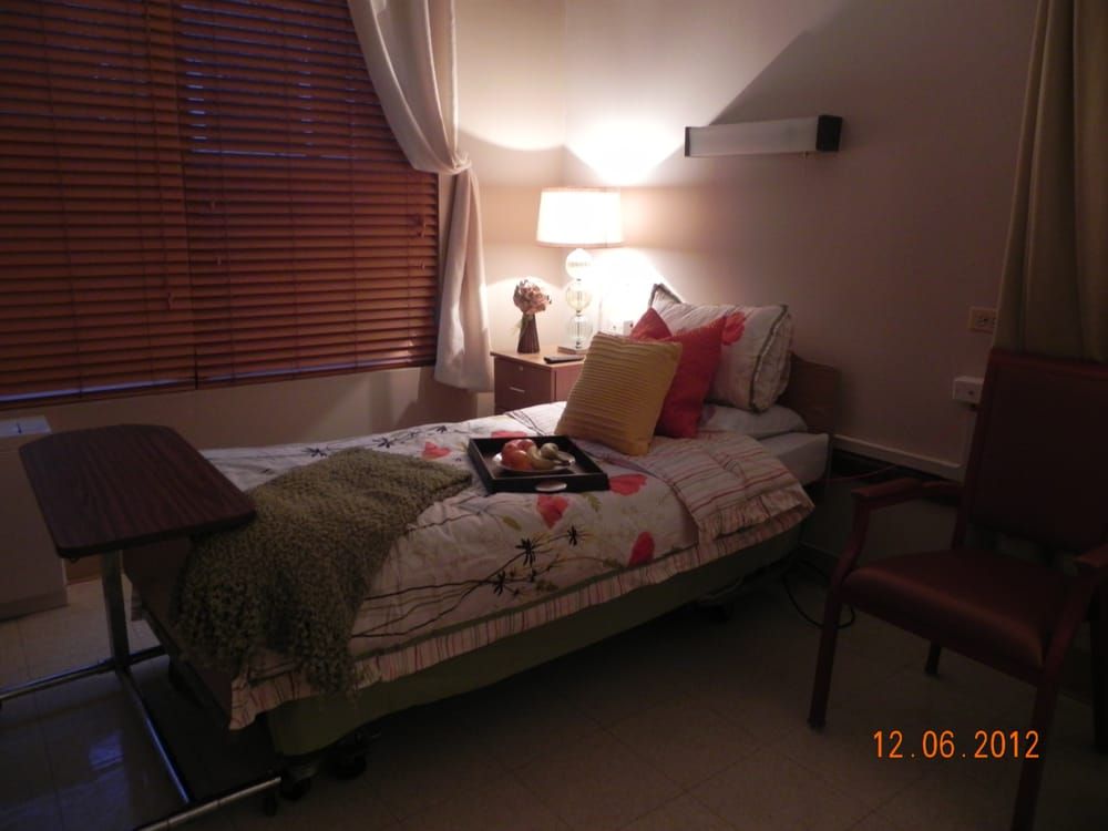 Interior view of a comfortable bedroom at Continental Nursing & Rehab Center, featuring modern decor.
