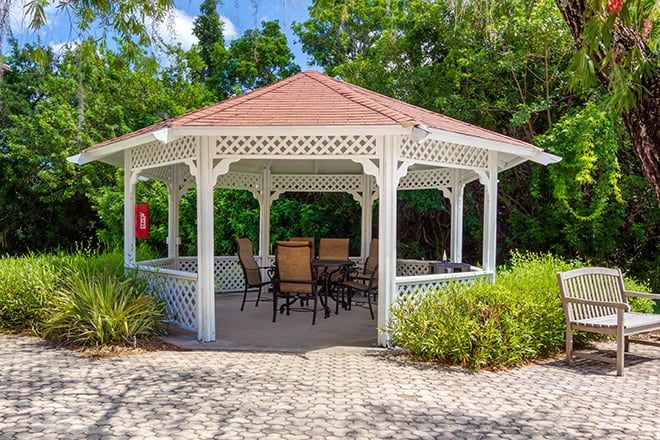 Exterior and interior views of Brookdale Phillippi Creek senior living community featuring a gazebo and furniture.
