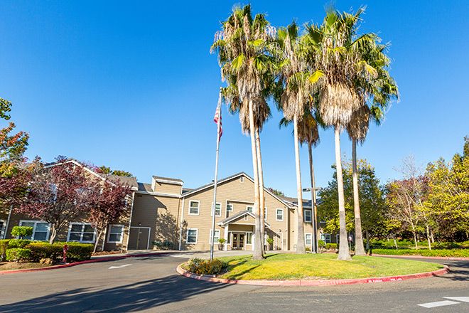 Senior living community, Sterling Court at Roseville, featuring lush vegetation and modern architecture.