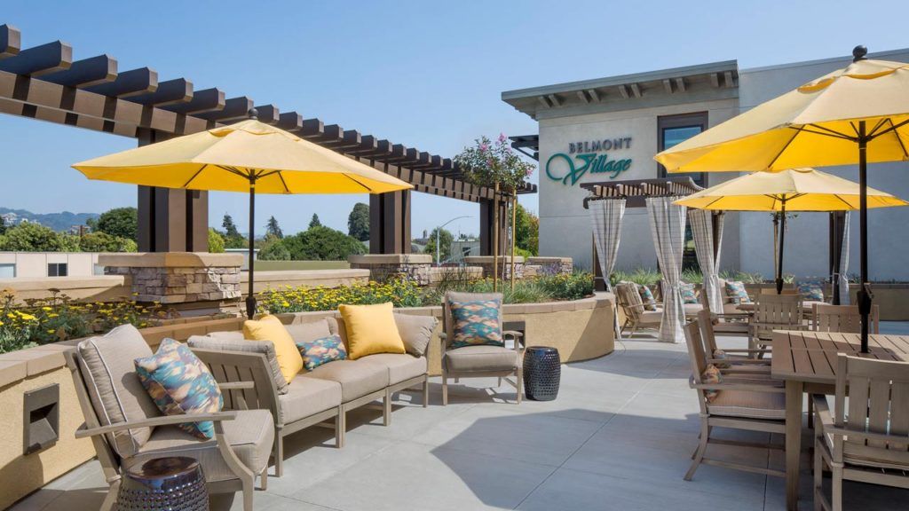 Terrace view of Belmont Village Senior Living Albany with patio furniture and dining area.