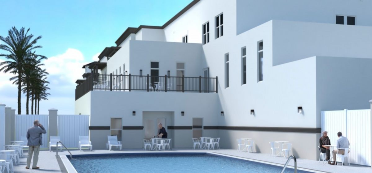 Senior living community, The Goldton at Venice, featuring villas, pool, and city view.