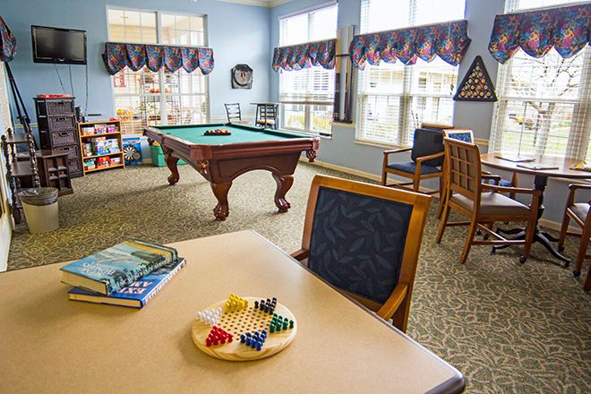 Interior view of Brookdale Goodlettsville senior living with furniture, dining and billiard room.