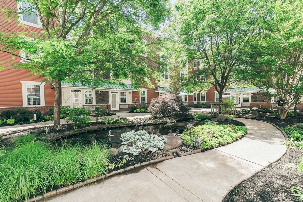 Senior living community, Woodbury Mews, showcasing its lush garden and urban architecture.