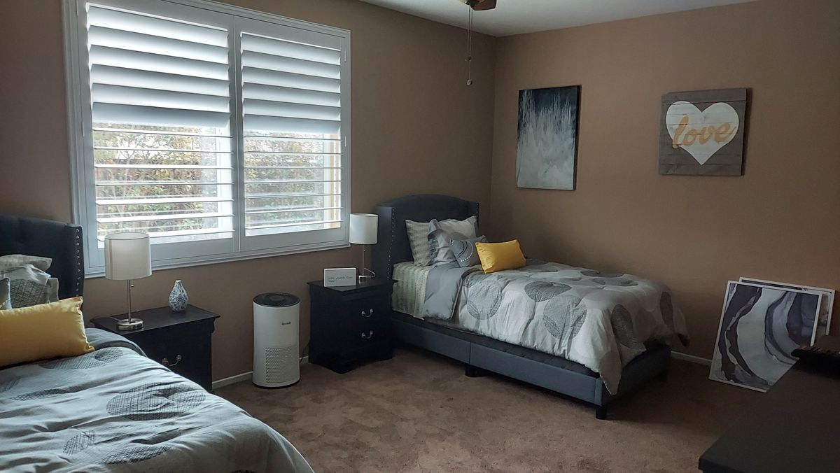 Platinum Buttercup senior living community featuring a well-furnished dorm room with home decor.